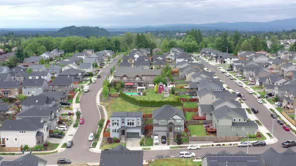 Aerial flying above houses in a typical middle class American subdivision.