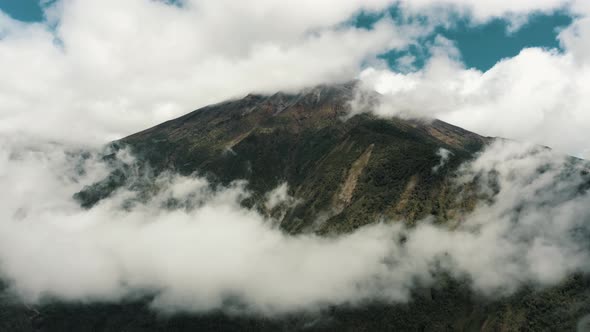 Beautiful White Clouds Enveloping Tungurahua Volcano Above Baños de Agua Santa In Ecuador. Aerial Sh