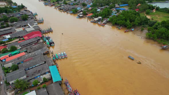 Aerial shot of river and local fisherman village beside the sea