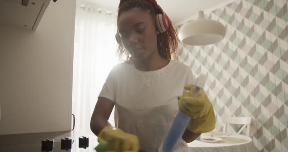 African American Woman Cleaning Stove