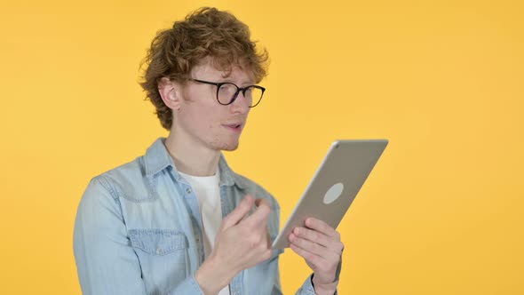 Redhead Young Man Using Digital Tablet Yellow Background