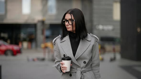 Confident and Independent Woman is Walking in Downtown in Autumn Day Drinking Coffee Take Away