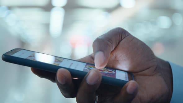 Man in a Protective Mask During an Epidemic Remains in Touch on the Internet on His Smartphone