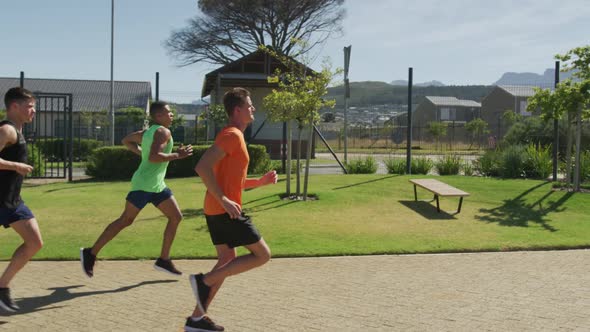 Men running outside on sunny day