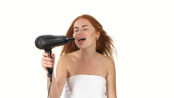 Smiling Young Redhead Girl Singing While Blow-dry, Bathroom
