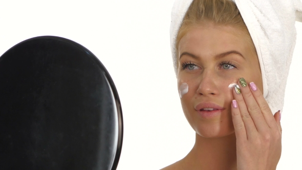 Beautiful Young Woman Applying Face Cream. , Bathroom