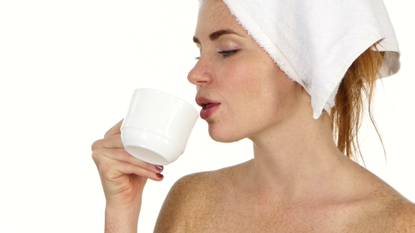 Girl Is Drinking Coffee. Her Eyes Are Closed With Pleasure And She Has Towel On Her Head, Bathroom