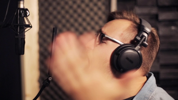 Man With Headphones Singing At Recording Studio 28