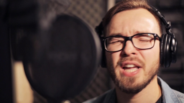 Man With Headphones Singing At Recording Studio 31