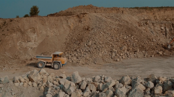 Dump Truck Loaded with Ore and Driving Through the Pit