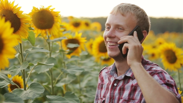 Young Farmer Speaks On The Phone.