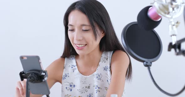 Woman having live stream on cellphone 