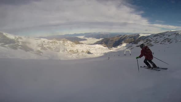 Young man skiing down a snow covered mountain.