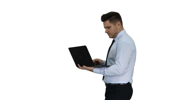 Formal man walking and using laptop on white background.