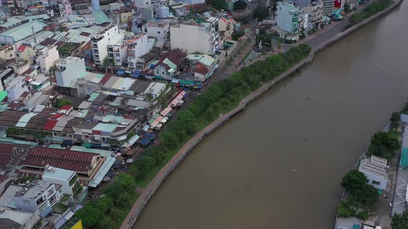 Aerial view along a canal in Binh Thanh district in Ho Chi Minh City (Saigon) Vietnam.Camera moves