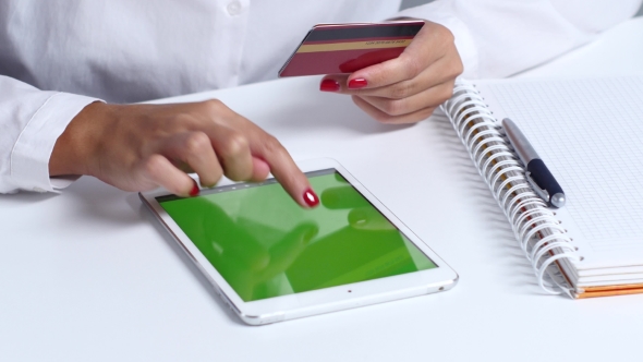 Woman Doing An Online Purchase With Credit Card And Tablet. 