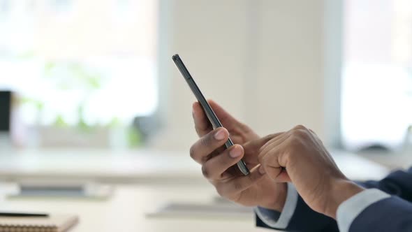 Hands of Businessman Typing on Smartphone Close Up