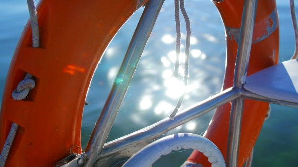 Life Preserver On a Yacht - The Reflection Of The Sun In Water