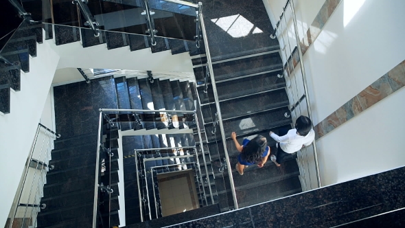 Business Couple Walking Up Stairs Together