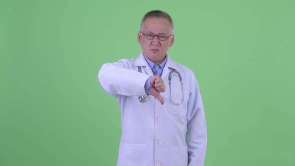 Angry Mature Japanese Man Doctor Giving Thumbs Down