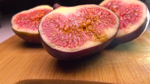 Beautiful Female Hand Taking The Half Of Fig.   Pan Shot