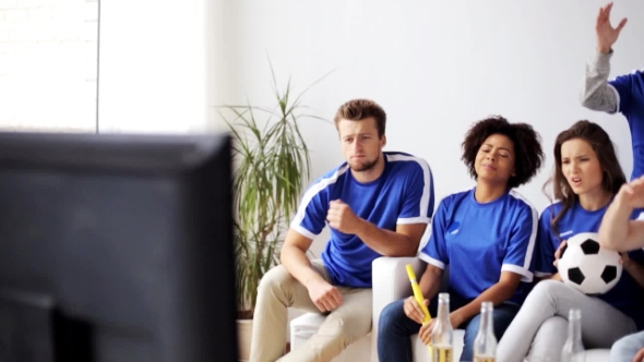 Friends Or Football Fans Watching Soccer At Home