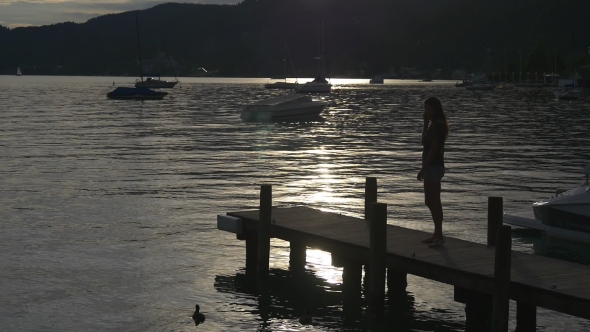 Motorboat Is Mooring To Jetty On Sunset