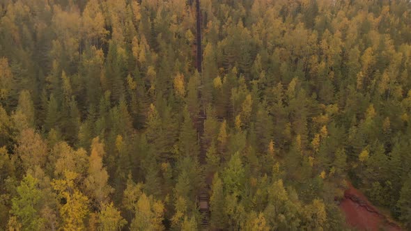 Aerial footage of drone flying upwoards a staircase on a hill.