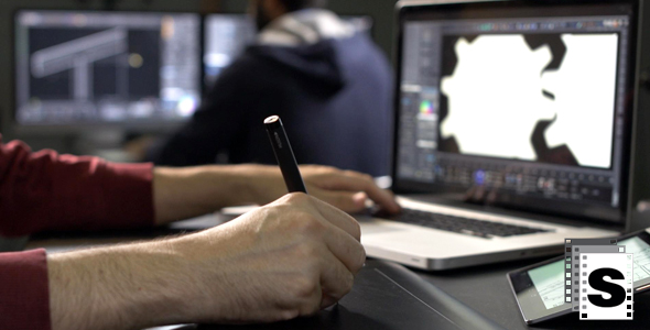 Graphic Designer Using Laptop And Digital Pen