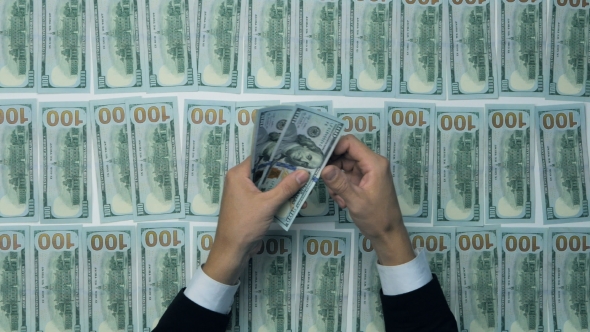 Unrecognizable Man Hands Counting Cash. Hundred New US Dollar Banknotes.