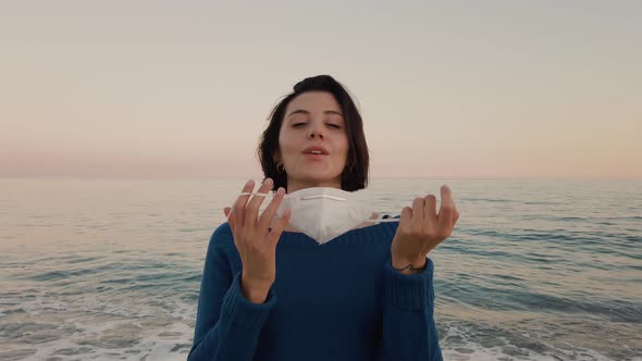 Girl with mask by the ocean