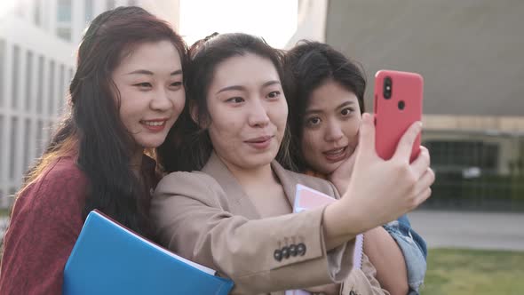 Group of female friends taking a selfie together with a mobile phone. Friendship concept.