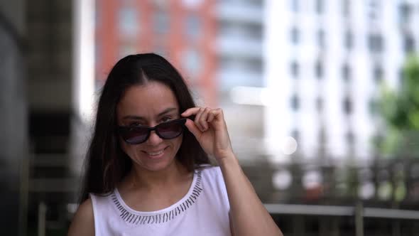 Portrait of Charming Middle-aged Brunette Woman in City Landscape, Smiling