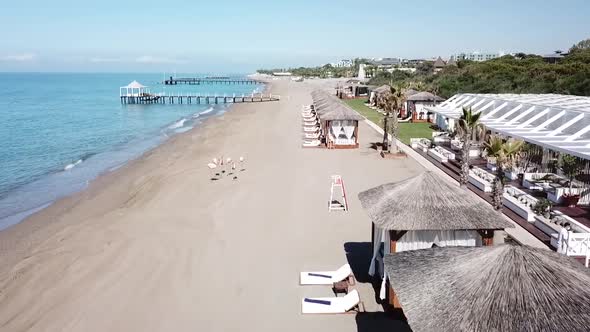 Quick flying over luxury beachside beds in low angle aerial shot