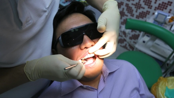 Dentist Is Healing Client Teeth With Mouth Mirror.