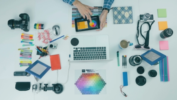 Unrecognizable Man Working On His Tablet In a Design Studio