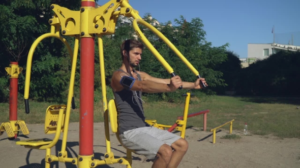 Bodybuilder Beginner Trains At The Open Air.