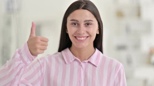 Positive Young Latin Woman Doing Thumbs Up 