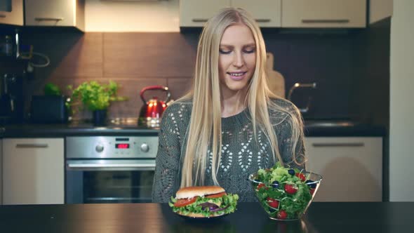 Young Lady Preferring Hamburger To Salad