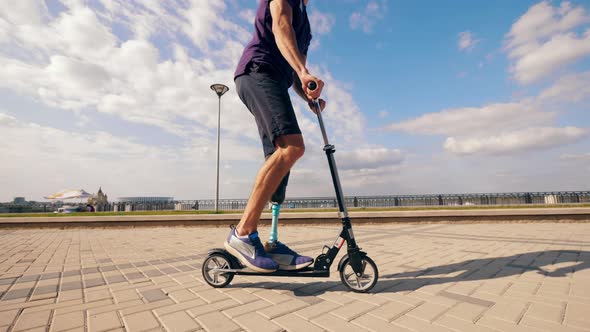 Scooter Is Being Handled By a Man with a Bionic Leg