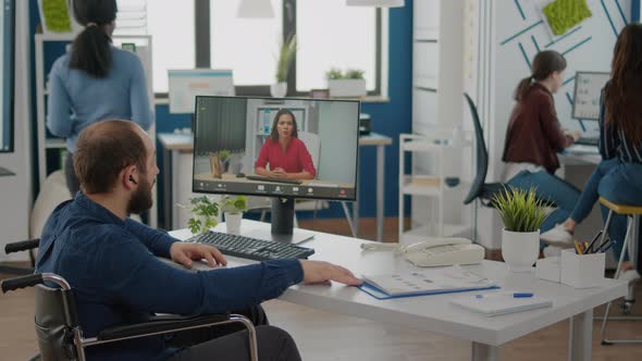 Invalid Manager Talking with Coworker During Video Conference