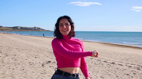 Young Woman Dancing on the Coastline and Laughing Slow Motion