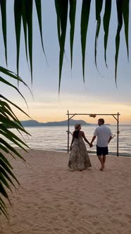 Men and Women Walking on the Beach in Pattaya During Sunset in Thailand Ban Amphur Beach