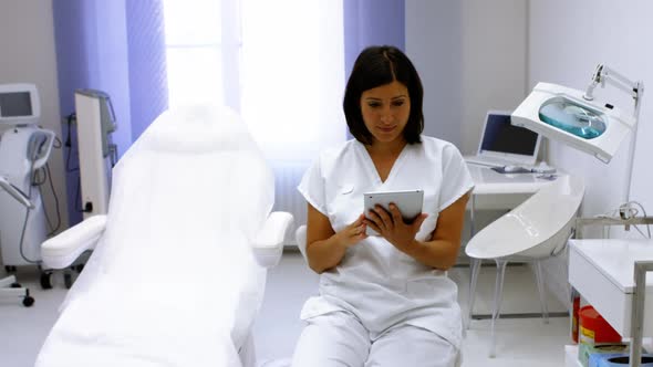 Doctor using digital tablet in clinic