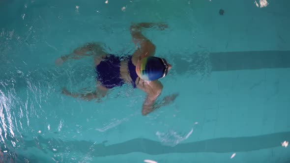 Female Swimmer Practicing Breaststroke