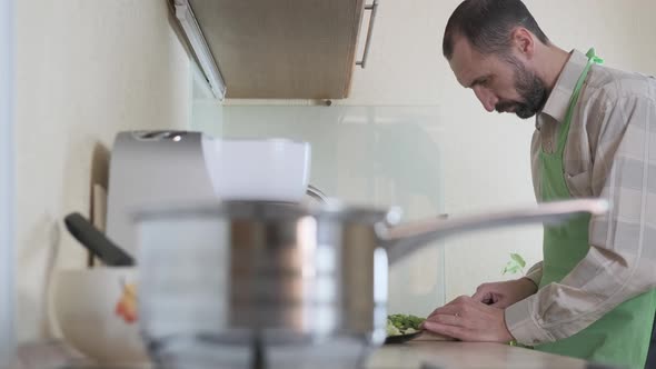 A man is cooking in the kitchen.