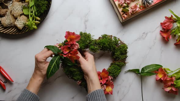 Hands Decorates Floral Wreath for Valentines Day