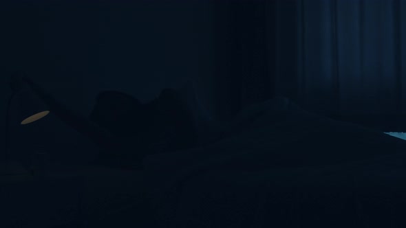 Asian young woman sleeping cozily in her bedroom.female hand turning off on light switch near bed.