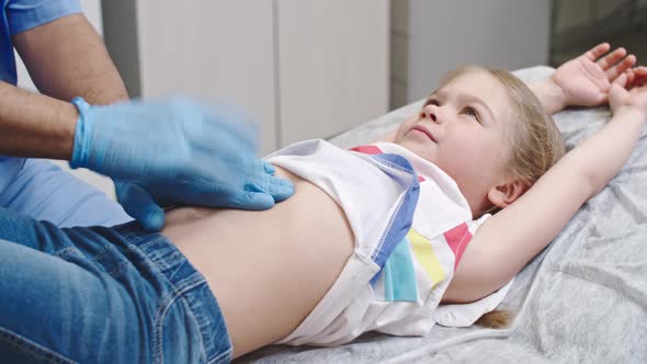 Doctor Performing Abdominal Examination