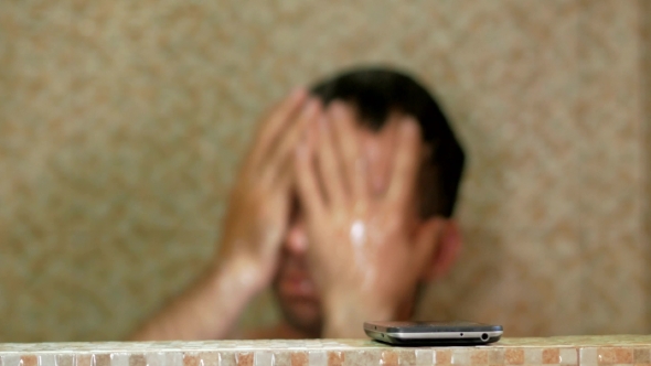 A Man Taking a Shower At The Hotel. Checks On The Phone Message, And Continues To Wash